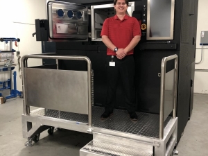 Zack Hopkins, Engineer II, Chromalloy Gas Turbine, with the company’s newly delivered Sapphire metal additive manufacturing system.