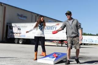 Public Relations/Loyalty Manager Cassidie Corwin (left) of event sponsor San Sebastian Winery, St. Augistine, Fla. plays bags with guest and United States Navy veteran Dr. Jon Cagan.