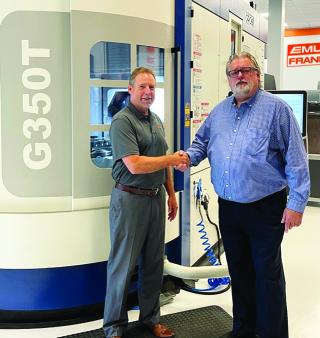 Emuge-Franken USA president Bob Hellinger (L) and Grob key account manager Kevin Gadde (R) share congratulatory wishes on their new partnership. Photo taken in front of the new Grob G350T 5-Axis mill-turn machine installed in the Emuge-Franken USA Technology Center in West Boylston, Massachusetts.