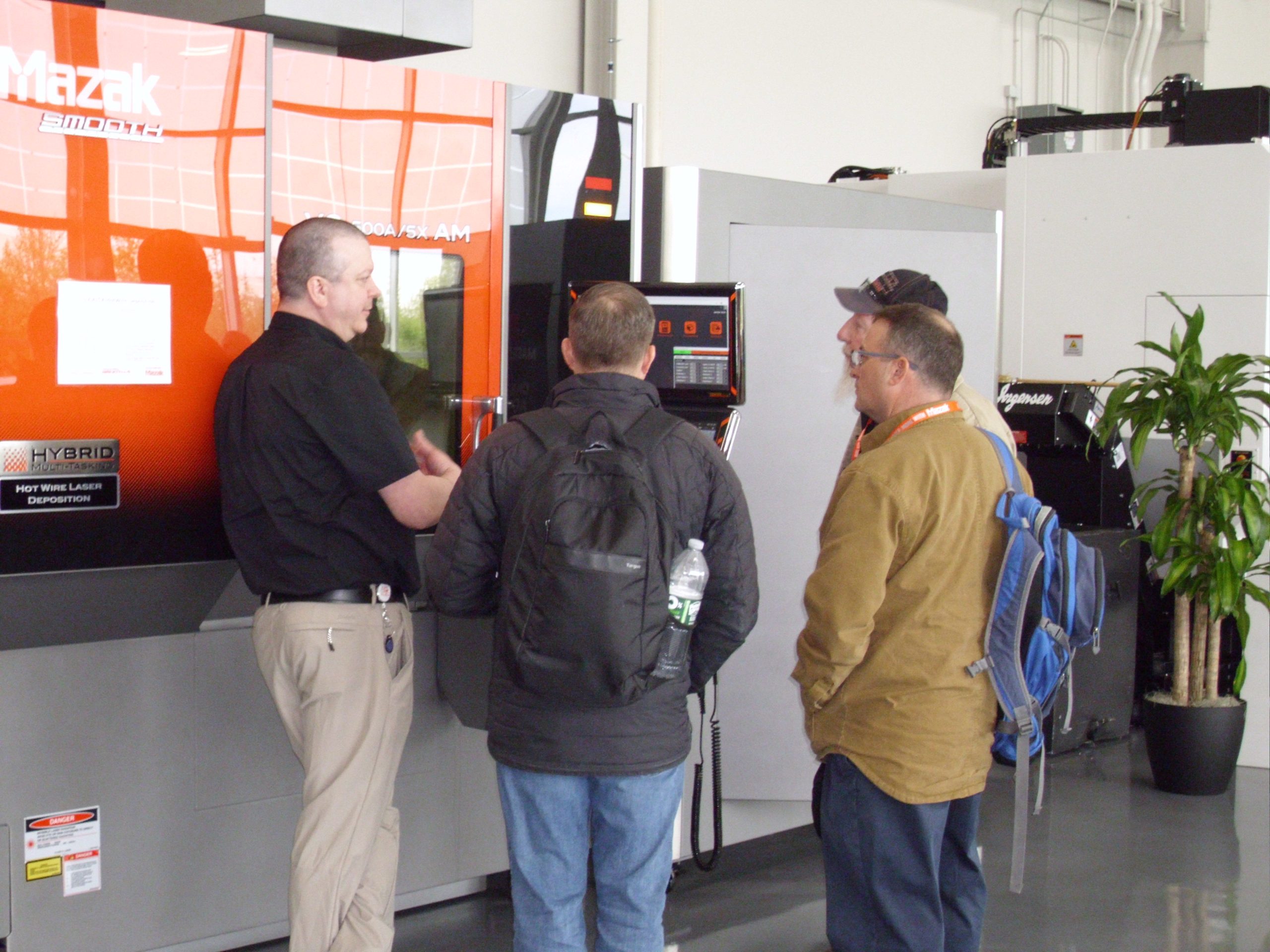 Attendees learning about the Mazak VC-500A/5X additive manufacturing machine