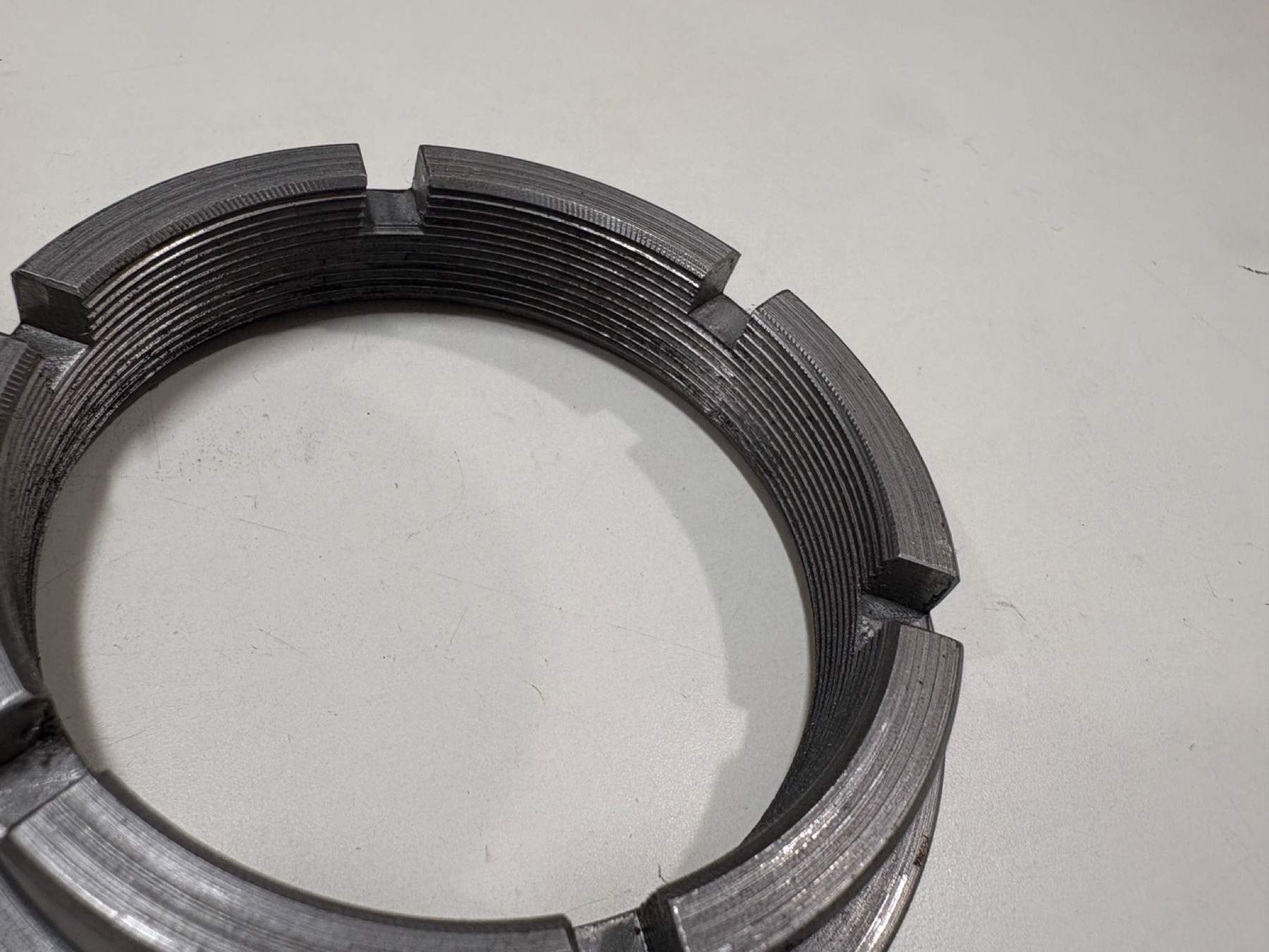 Custom castle-style lock nut for a Formula SAE wheel hub