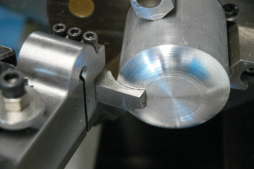 The spring-type toolholder with its pivot above the centerline backs the cutting edge off when the tool bites and starts to chatter. Image courtesy of Tom Lipton.