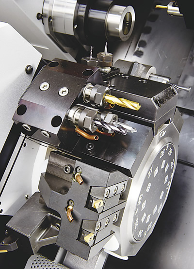 Turrets offer excellent rigidity, flexibility and tool selection. Here, dozens of tool positions are available on the twin turrets of this Cincom M-series Swiss-style CNC lathe. Turrets offer excellent rigidity, flexibility and tool selection. Here, dozens of tool positions are available on the twin turrets of this Cincom M-series Swiss-style CNC lathe.