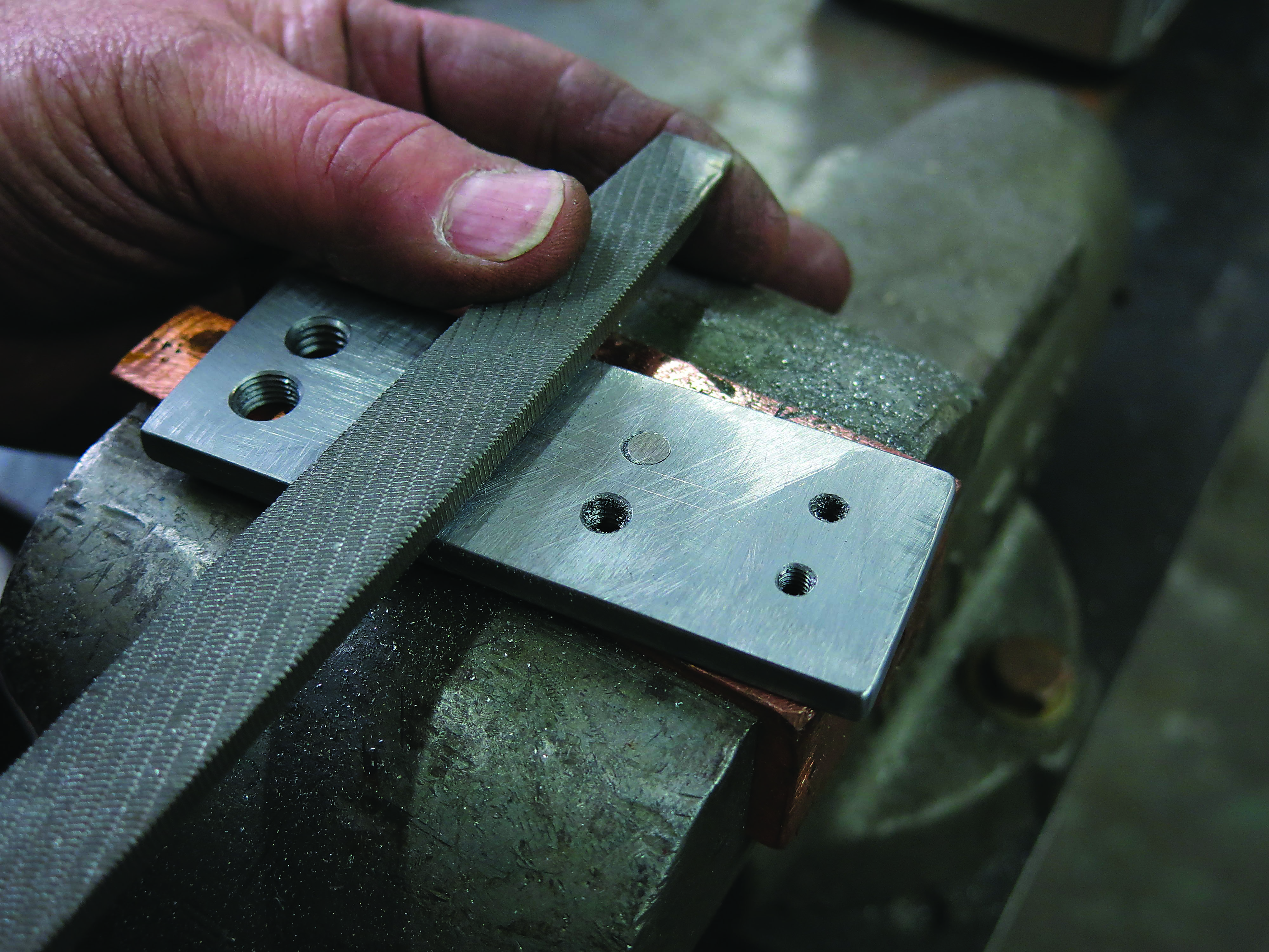 An offending projection is ground or filed until it is flush with the plate. Image courtesy of Tom Lipton.