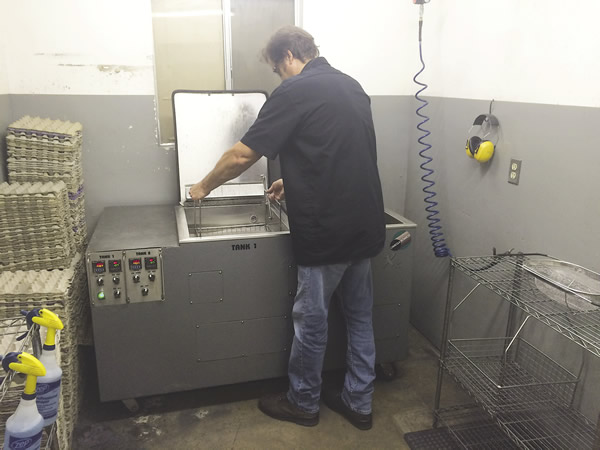 Lou Tignac, owner and president of Van's Manufacturing, removes a basket of parts from the company's Omegasonics Super Pro X2 ultrasonic parts cleaning machine. All images courtesy Omegasonics. Lou Tignac, owner and president of Van's Manufacturing, removes a basket of parts from the company's Omegasonics Super Pro X2 ultrasonic parts cleaning machine. All images courtesy Omegasonics.