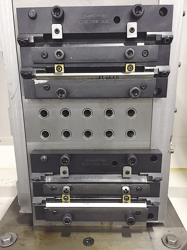 A tombstone on a horizontal machining center at Mitsubishi Hitachi Power Systems Americas' machine shop is an example of a fixture that can be used on all machining centers, including verticals, because it has a common locating pattern. A tombstone on a horizontal machining center at Mitsubishi Hitachi Power Systems Americas' machine shop is an example of a fixture that can be used on all machining centers, including verticals, because it has a common locating pattern.