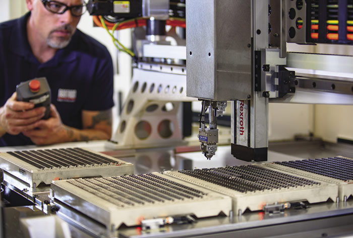 Chuck Best, CNC operator and technician at Illinois Carbide Tool, sets parameters for the Leo Peri grinder's pick-and-place robot. Chuck Best, CNC operator and technician at Illinois Carbide Tool, sets parameters for the Leo Peri grinder's pick-and-place robot.
