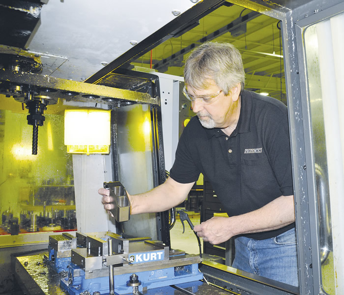 Les Smith, Protomatic's senior machinist, loads a rocket-engine component made of Inconel 718 into a Mazak Quick Turn Nexus 200-II M. Image courtesy Protomatic. Les Smith, Protomatic's senior machinist, loads a rocket-engine component made of Inconel 718 into a Mazak Quick Turn Nexus 200-II M. Image courtesy Protomatic.