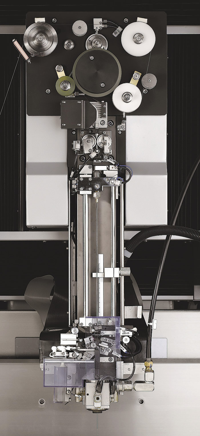 At top is the tortuous path a wire must take through an EDM. Below is Sodick's formerly used tube mechanism for threading water-dielectric EDMs. Image courtesy Sodick. At top is the tortuous path a wire must take through an EDM. Below is Sodick's formerly used tube mechanism for threading water-dielectric EDMs. Image courtesy Sodick.
