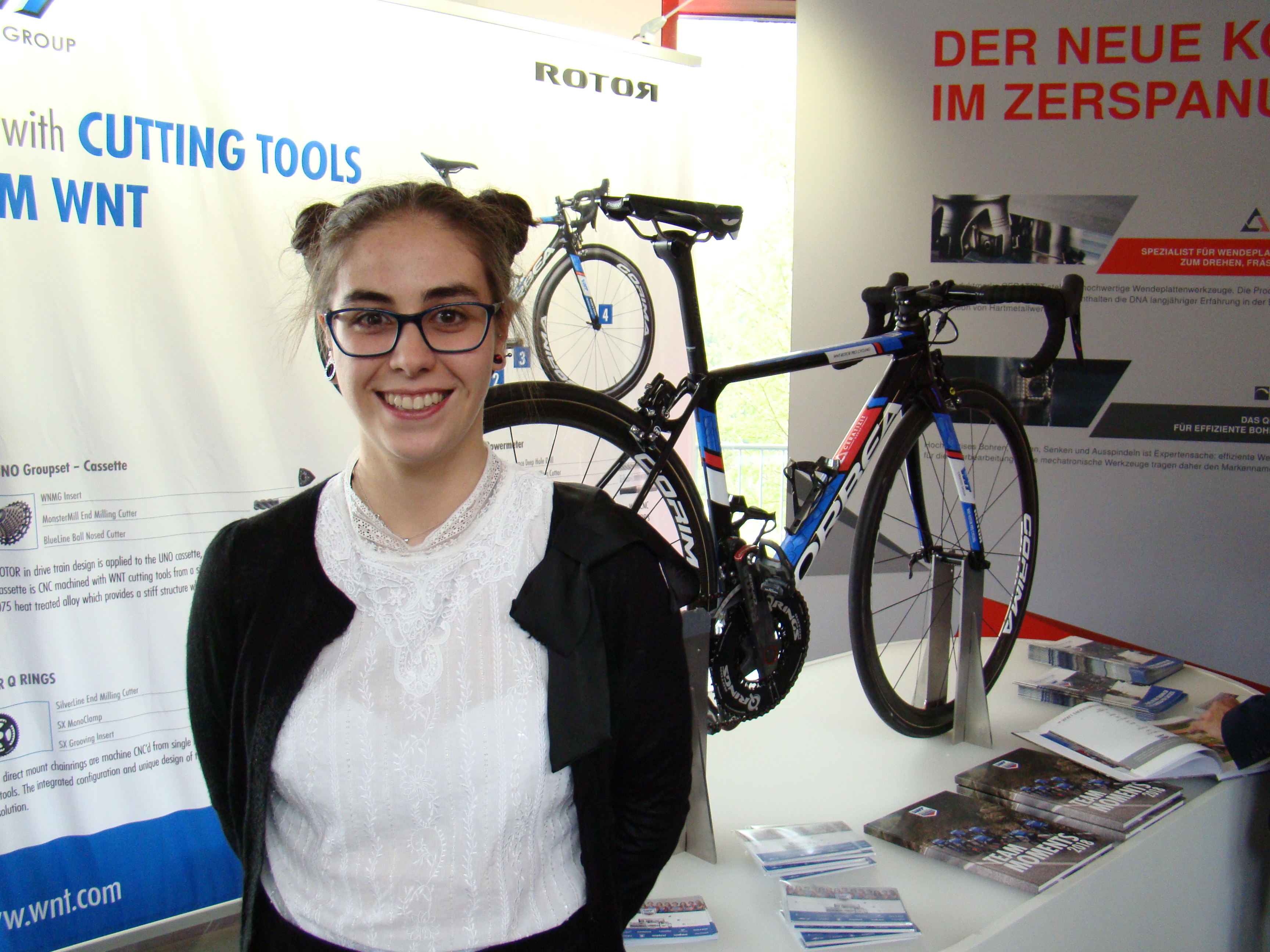 Maria del Rey, quality technician for Ajalvir, Spain-based EDR System SA, poses with a bike riden by Kirsten Wild. Photo by Alan Richter