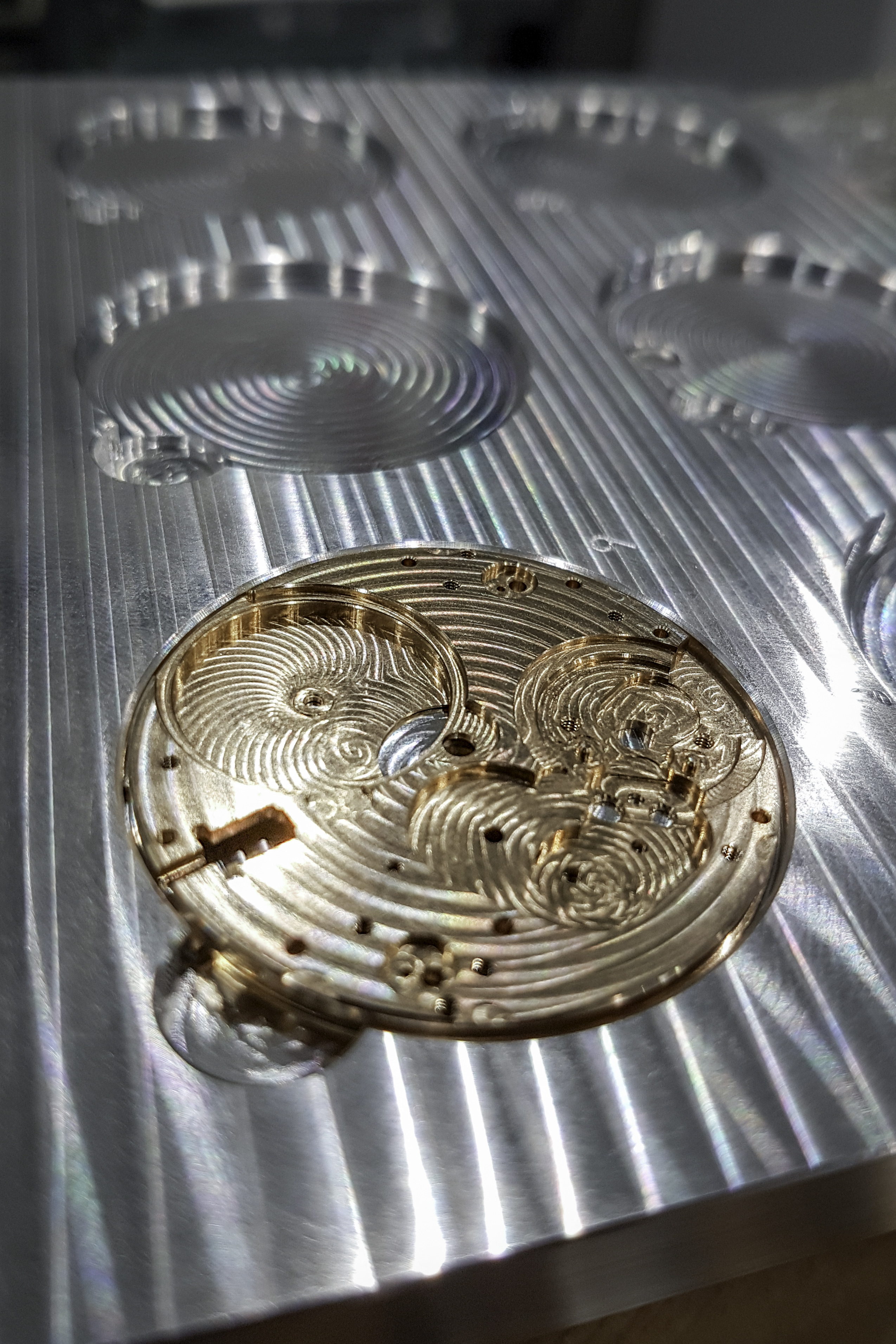 Watchmaker manufactures small parts with a high-precision machine tool image