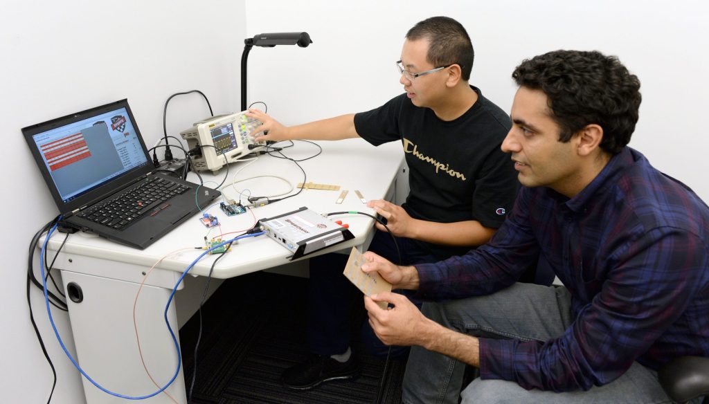 Picture of Postdoctoral fellow Ju Wang right and Professor Omid Abari