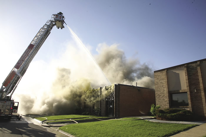 Firefighters work to extinguish a fire at Taurus Tool's previous facility in Schaumburg, Ill.