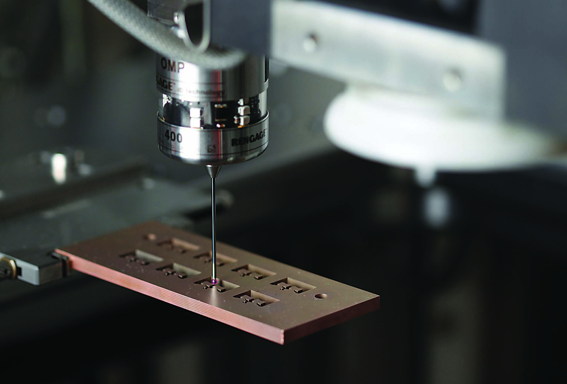 A probe performs in-process gaging on a wire EDMed part.
