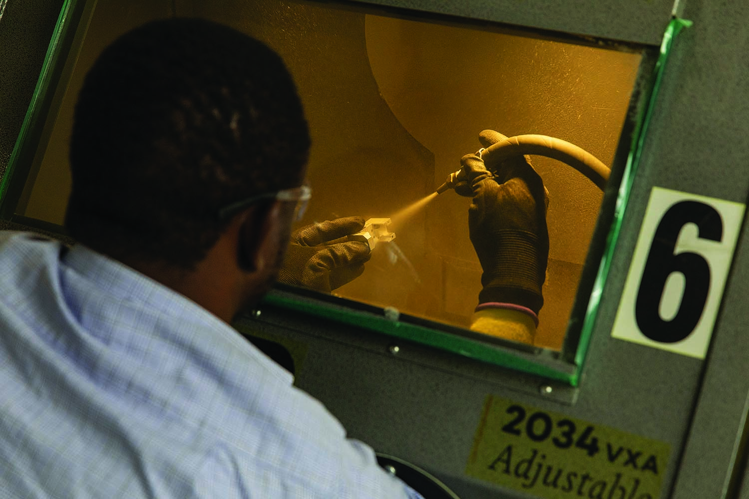 Some metal parts manufactured at Protolabs' main CNC machining facility receive a light bead blast in the finishing area.