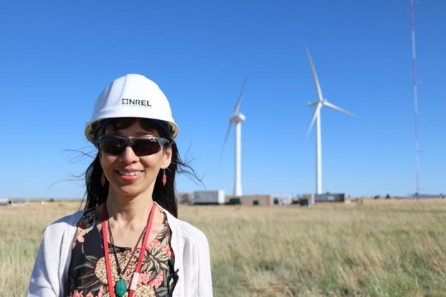 Lucy Pao stands at the National Renewable Energy Laboratory's Flatirons campus with the 53.38-kW SUMR-D directly to her right.