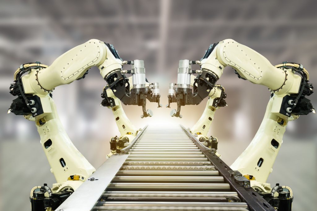 iot 4.0 technology concept.Smart factory using trending automation robotic arms with part on conveyor belt in operation line. Automotive manufacturing use it for precision, Repetition, intense