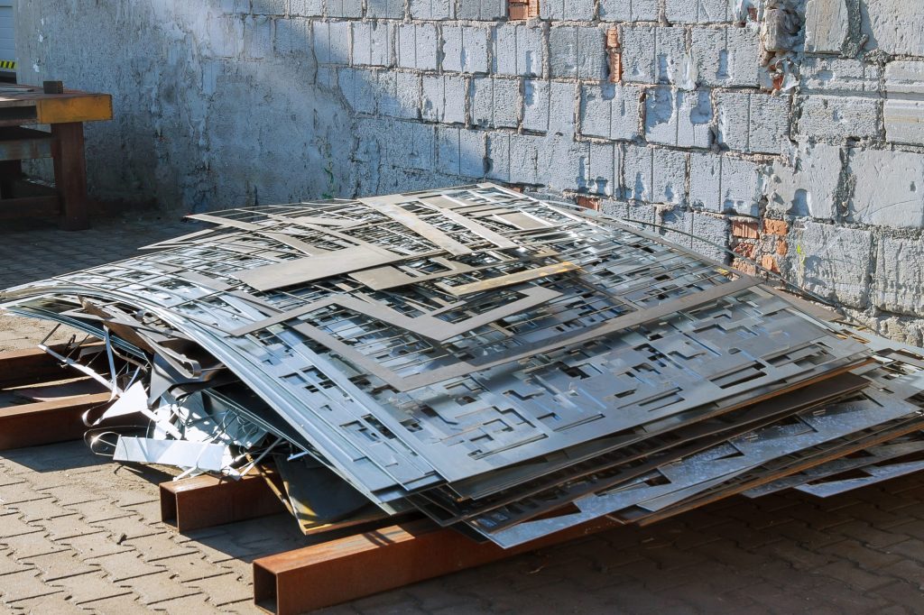 Waste metal after cutting sheet metal on a CNC machine. CNC laser for metal cutting. Heavy industry.